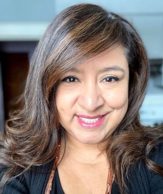 Sonia Gomez, Practice Manager at First Response Legal, smiling warmly, with a professional demeanor, reflecting her role in providing compassionate client support in family law.